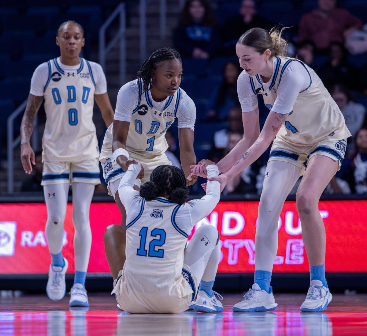 Riley Stack and Kelsey Thompson help Alisha Nunley off the floor.